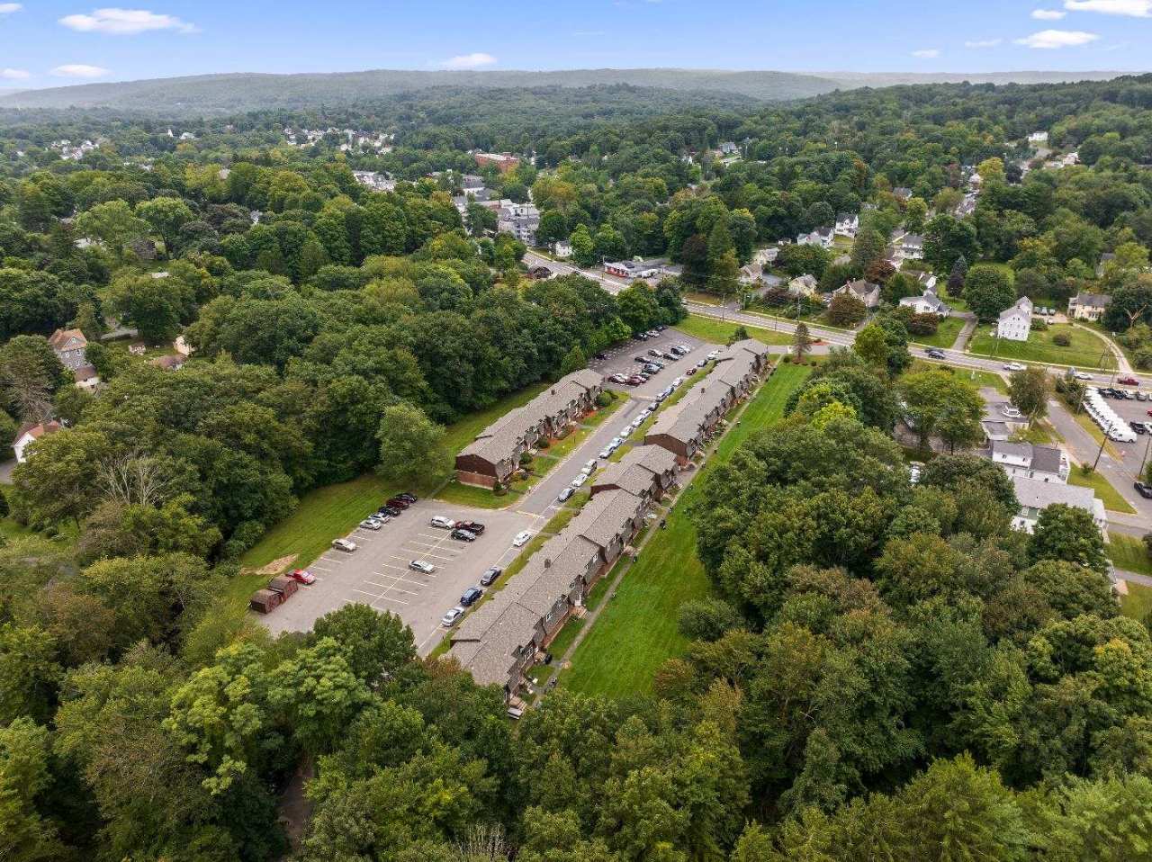 Overhead view of the buildings, central drive, parking and rear lawn