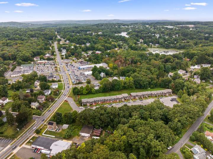 Aerial view of the property with the pond beyond