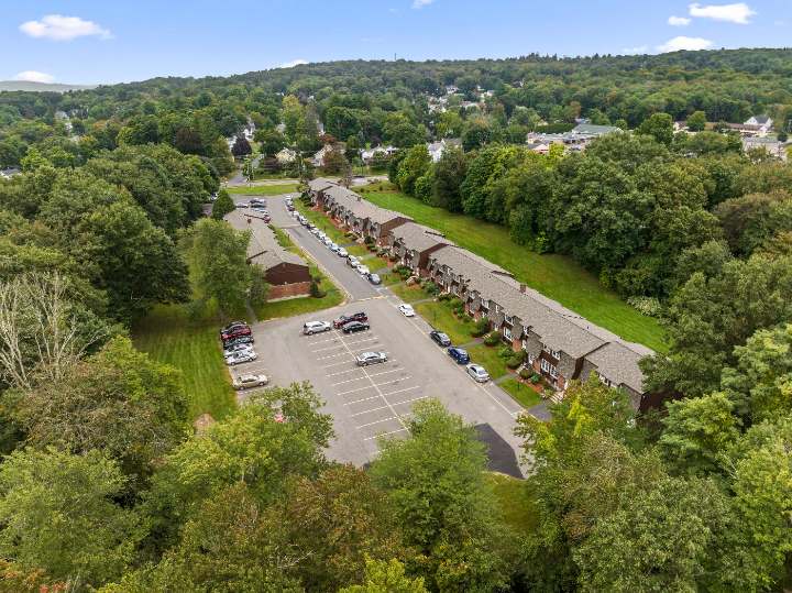 Aerial view of the property and surrounding trees