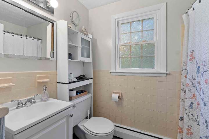 Bathroom with tiled walls and window