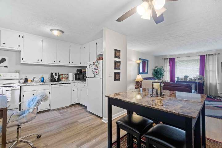 Kitchen and dining area with white cabinetry